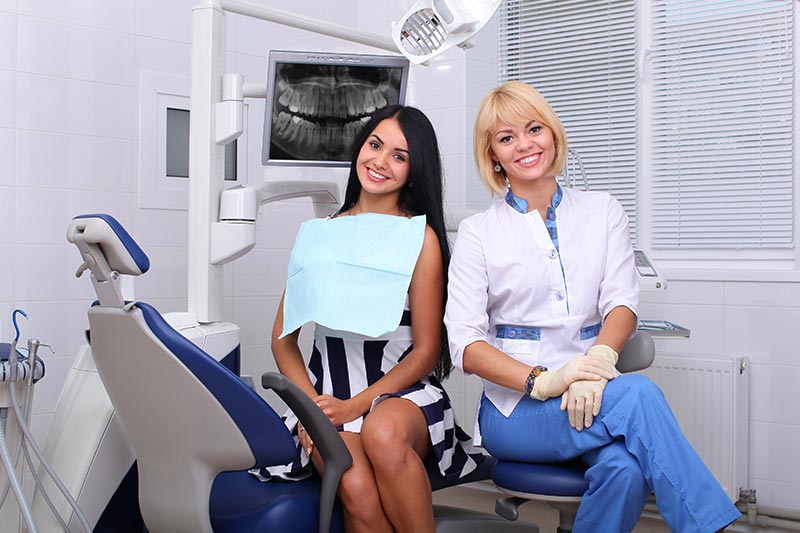 Dentist sits in with her patient